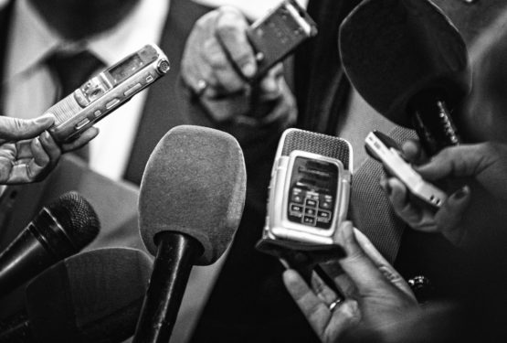 Journalists interviewing with microphones