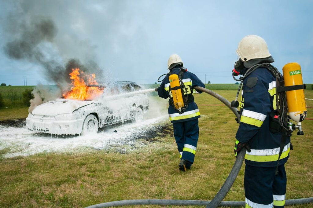 Firefighters spray foam over a burning car - a visual metaphor for a good crisis communications response