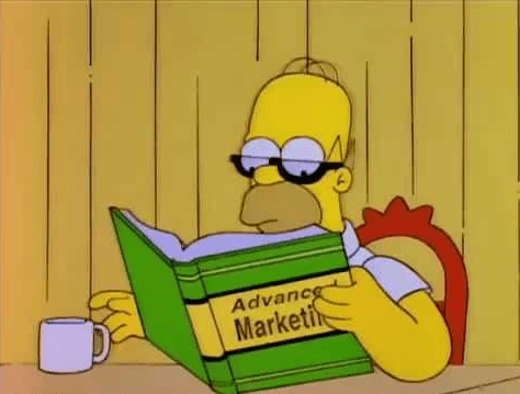 Homer Simpson reads a book on marketing