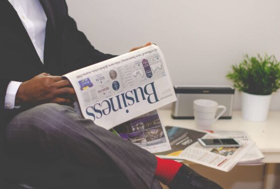 Man reading the business pages of a newspaper