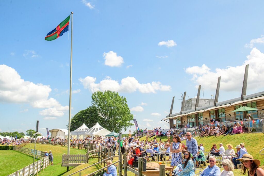 People sat on the grass watching a show at The Lincolnshire Show 2023