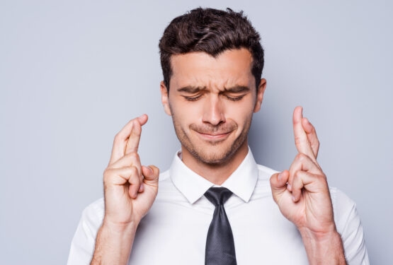 Man with crossed fingers