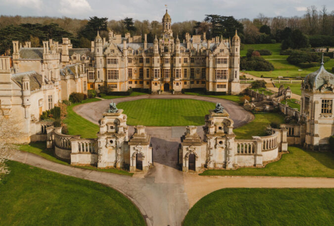 The impressive exterior of Harlaxton Manor on a bright, sunny day