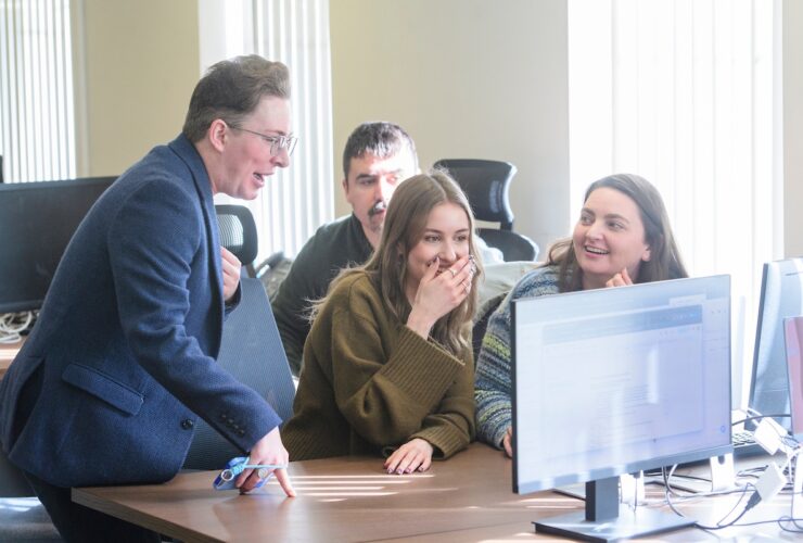 The Carrington marketing team look at something that makes them laugh